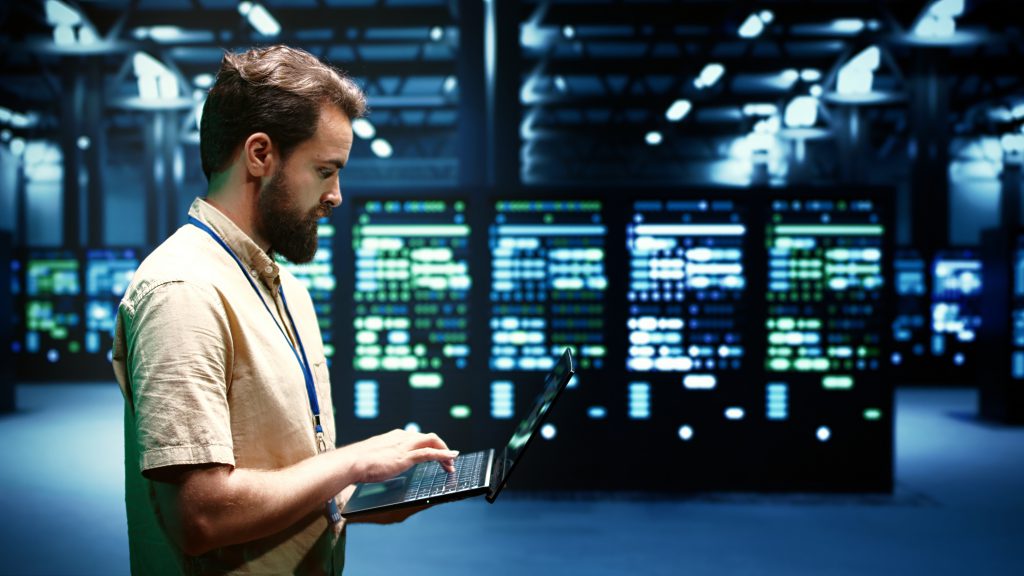 IT specialist monitoring cloud infrastructure on screen